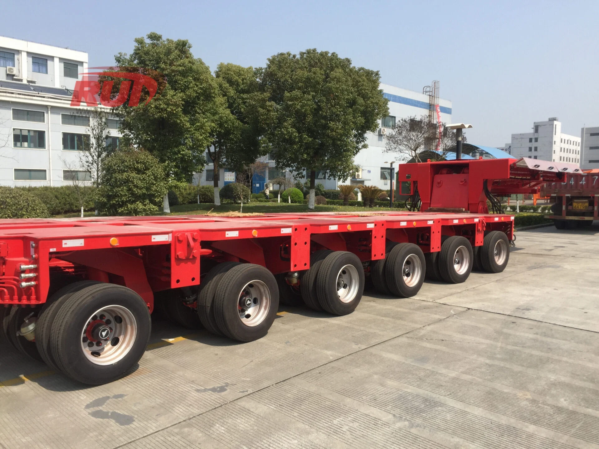 Heavy-duty dump trailer with hydraulic jack on black and gray frame