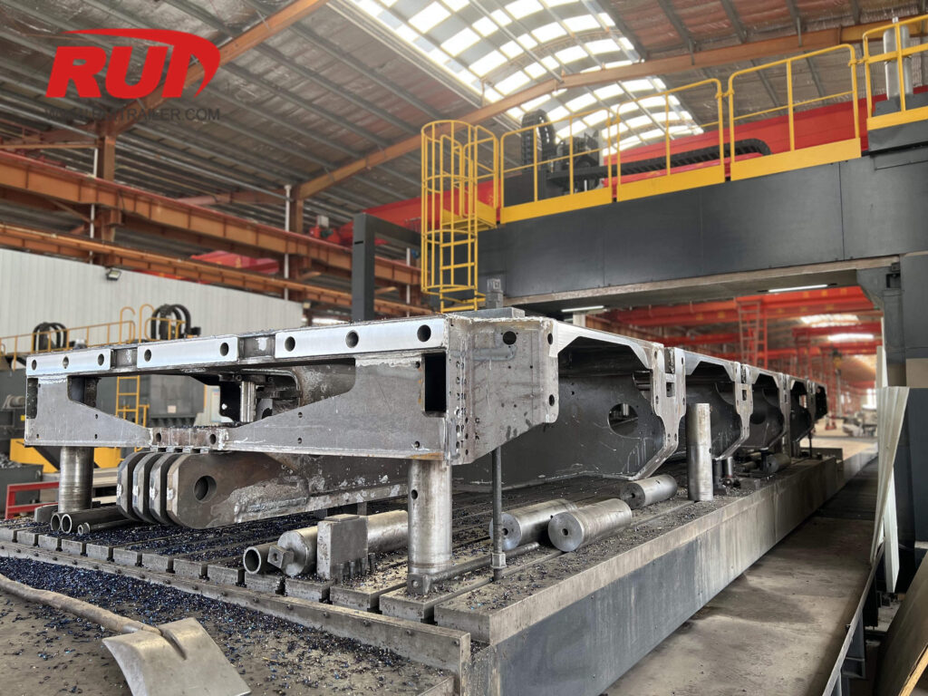 CNC-Geländesfräsmaschine für die Herstellung hydraulischer Modularanhänger a view of semi trailer frame being processed in a manufacturing facility
